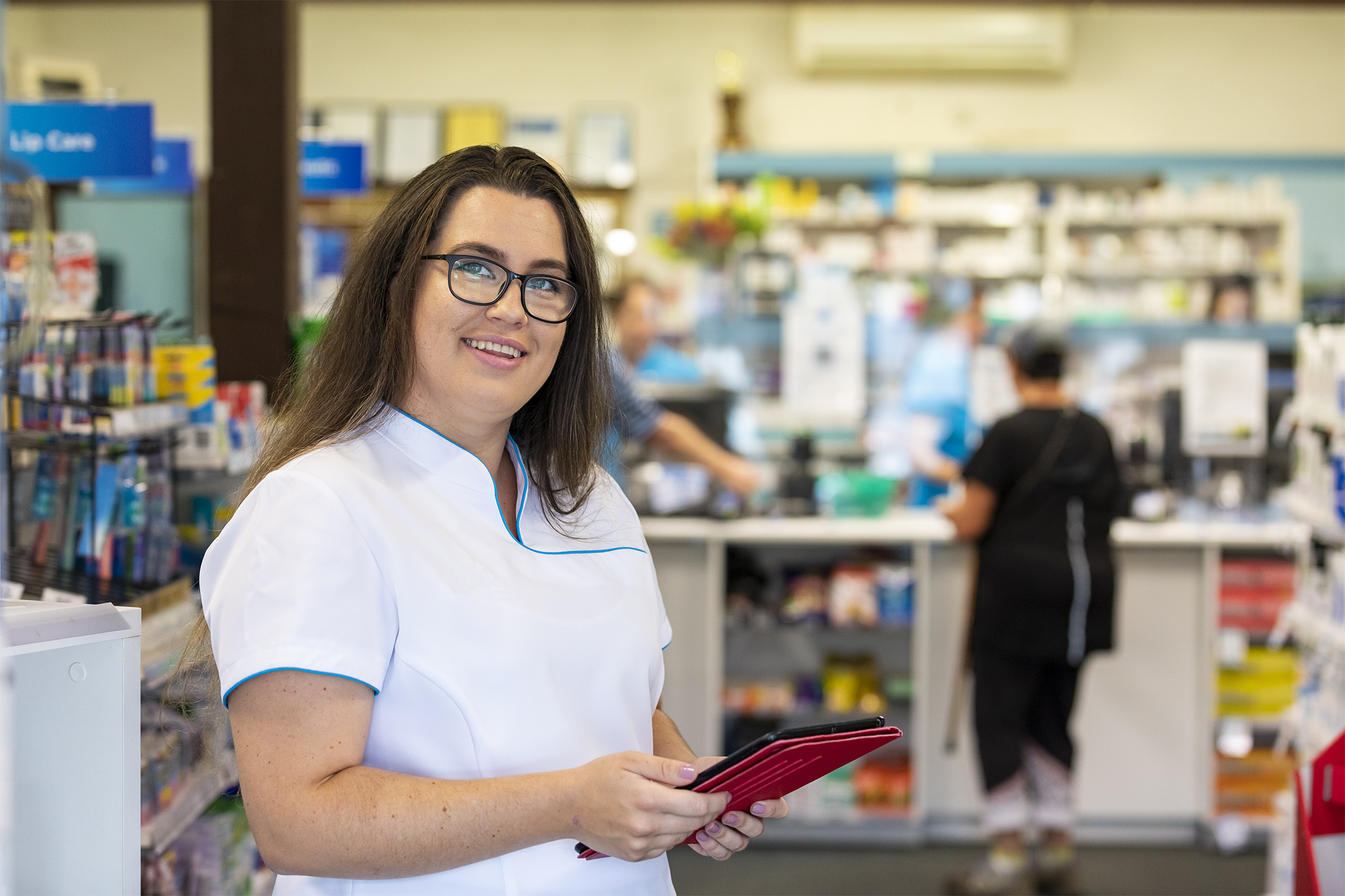Image of female pharmacist holding an ipad