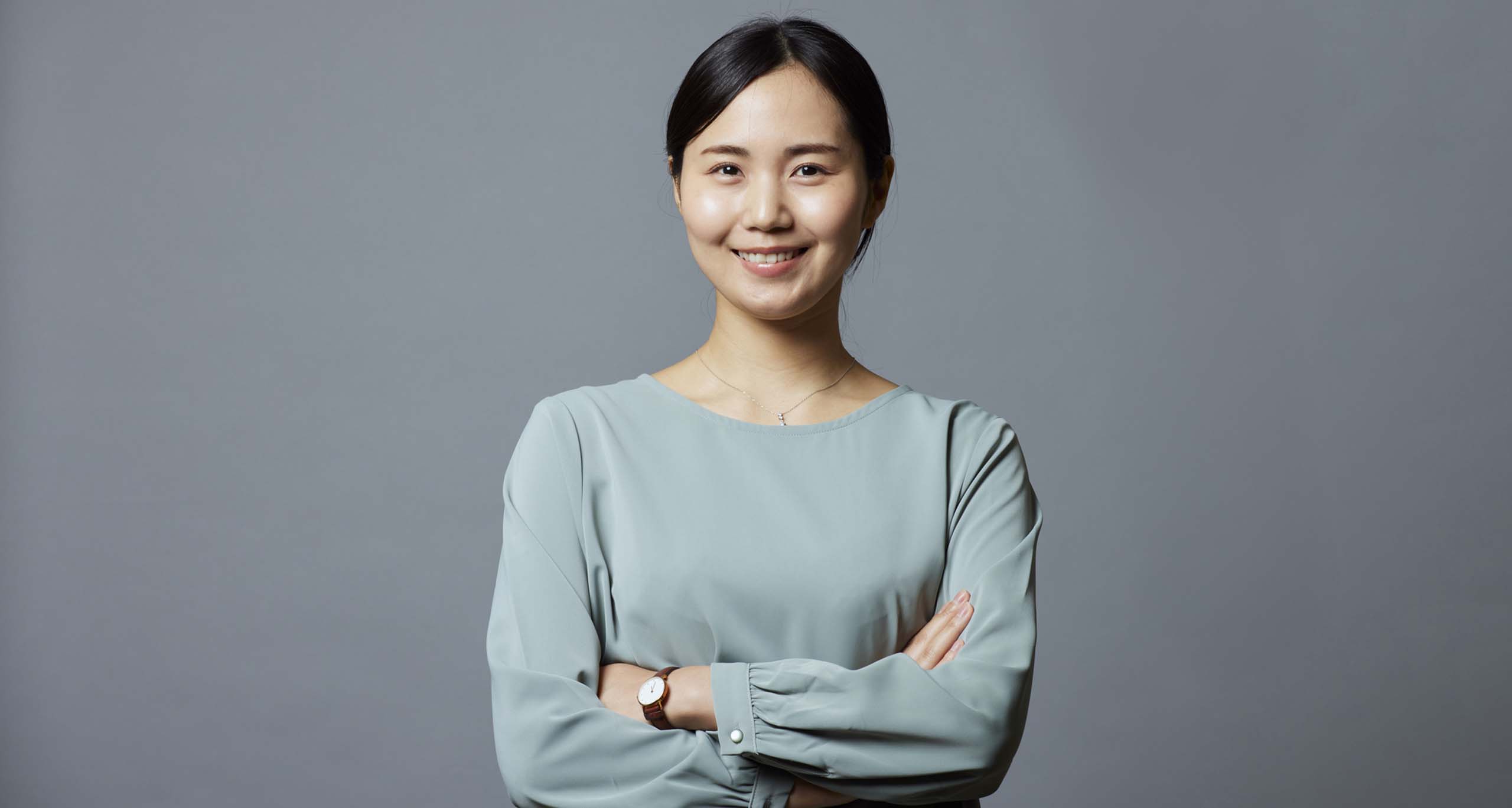 Image of an asian woman with arms crossed